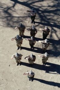 Aerial view of rangers in salute formation during anti-poaching drills at Camp Rhino, Namibia